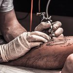 pngtree-tattoo-artist-at-work-process-creative-tattoo-photo-image_46107446